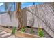 Landscaped backyard with raised garden beds along a textured wall, perfect for a home garden at 2595 Aviv Ct, Las Vegas, NV 89121