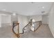 Hallway featuring elegant staircase with decorative wrought iron spindles and neutral carpet at 2595 Aviv Ct, Las Vegas, NV 89121