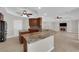 Open kitchen showcasing a granite island, stainless appliances, and breakfast bar at 2595 Aviv Ct, Las Vegas, NV 89121
