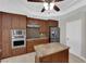 Modern kitchen features an island, stainless appliances, and wood-look floors at 2595 Aviv Ct, Las Vegas, NV 89121
