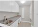 Bright laundry room with sink, storage, and counter space at 2595 Aviv Ct, Las Vegas, NV 89121