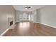 Open living room featuring hardwood floors, neutral paint, and a stone fireplace at 2595 Aviv Ct, Las Vegas, NV 89121
