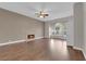 Spacious living room featuring a fireplace, hardwood floors, natural light, and ceiling fan at 2595 Aviv Ct, Las Vegas, NV 89121