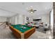 Spacious living room featuring a pool table, neutral tones, comfortable seating, and modern decor at 2595 Aviv Ct, Las Vegas, NV 89121