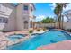 Beautiful backyard pool and spa combination with mature palm trees and ample patio space at 2595 Aviv Ct, Las Vegas, NV 89121