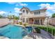 Sparkling pool, spa, and rock features with lush landscaping in backyard at 2595 Aviv Ct, Las Vegas, NV 89121