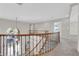 View of curved staircase with wooden handrail and iron balusters at 2595 Aviv Ct, Las Vegas, NV 89121