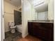 Well-lit bathroom featuring a combination tub and shower and dark vanity at 2606 S Durango Dr # 171, Las Vegas, NV 89117