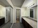 Bathroom featuring dark wood cabinets, granite countertop, and tiled shower at 2606 S Durango Dr # 171, Las Vegas, NV 89117