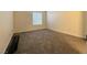 Carpeted bedroom featuring neutral walls and a window for natural light at 2606 S Durango Dr # 171, Las Vegas, NV 89117