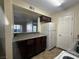 Functional kitchen with dark wood cabinets, white refrigerator, and open layout at 2606 S Durango Dr # 171, Las Vegas, NV 89117