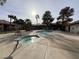 Community pool surrounded by palm trees and lounge chairs at 2606 S Durango Dr # 171, Las Vegas, NV 89117