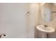 Clean bathroom with a pedestal sink, round mirror, and modern fixtures at 2862 Starling Summit St, Henderson, NV 89044