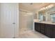 Bathroom boasts a walk-in shower, dual sink vanity, and tile flooring at 2862 Starling Summit St, Henderson, NV 89044