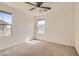 A carpeted bedroom bathed in sunlight from two bright windows and featuring a ceiling fan at 2862 Starling Summit St, Henderson, NV 89044