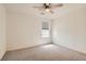 A cozy carpeted bedroom with a modern ceiling fan and a bright window for natural light at 2862 Starling Summit St, Henderson, NV 89044