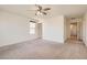 A spacious bedroom featuring a ceiling fan, neutral carpet, and bright natural light from the window at 2862 Starling Summit St, Henderson, NV 89044