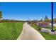 Potenza Park entrance with paved pathway and green grass leading into the park with mountain views at 2862 Starling Summit St, Henderson, NV 89044