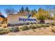 Entrance to Inspirada community featuring lush landscaping, a hummingbird logo, and the community name at 2862 Starling Summit St, Henderson, NV 89044