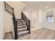 Entryway featuring tiled floors, natural light, and a carpeted staircase to the upper level at 2862 Starling Summit St, Henderson, NV 89044