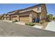 Street view of tan townhomes with individual garages and landscaped frontages at 2862 Starling Summit St, Henderson, NV 89044