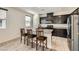 Modern kitchen featuring granite countertops, dark cabinets, and stainless steel appliances at 2862 Starling Summit St, Henderson, NV 89044