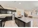 Beautiful kitchen with granite island, dark cabinets, and stainless appliances in an open layout at 2862 Starling Summit St, Henderson, NV 89044