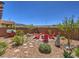 Beautiful backyard featuring a cozy seating area with a firepit, surrounded by lush landscaping and stone pathways at 2936 Aragon Terrace Way, Henderson, NV 89044