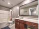 Full bathroom with shower-tub, stylish vanity, a large mirror, and neutral color scheme at 2936 Aragon Terrace Way, Henderson, NV 89044