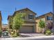 Attractive exterior shot of a two story home with a two car garage and desert landscaping under a clear blue sky at 2936 Aragon Terrace Way, Henderson, NV 89044