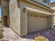 Close up of two car garage with brick paved driveway and desert landscaping at 2936 Aragon Terrace Way, Henderson, NV 89044