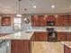 Modern kitchen featuring dark wood cabinets, granite countertops, and stainless steel appliances at 2936 Aragon Terrace Way, Henderson, NV 89044