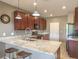 Well-equipped kitchen featuring granite countertops, dark wood cabinets, and stainless steel appliances at 2936 Aragon Terrace Way, Henderson, NV 89044