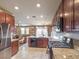 Modern kitchen features granite countertops, stainless steel appliances, and an open floor plan to the living area at 2936 Aragon Terrace Way, Henderson, NV 89044