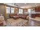 Open concept living area with modern decor, a large leather sectional sofa, and wood flooring at 2936 Aragon Terrace Way, Henderson, NV 89044