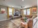 Spacious living room featuring hardwood floors, modern decor, and lots of natural light at 2936 Aragon Terrace Way, Henderson, NV 89044
