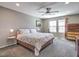 The spacious primary bedroom has a ceiling fan, plush carpet, a queen bed, and great natural light at 2936 Aragon Terrace Way, Henderson, NV 89044