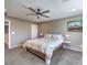 Bright primary bedroom featuring plush carpet, a queen bed, ceiling fan, and natural light from windows at 2936 Aragon Terrace Way, Henderson, NV 89044
