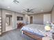 The main bedroom features plush carpet, a queen bed, ceiling fan, and en suite bathroom at 2936 Aragon Terrace Way, Henderson, NV 89044