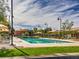 Community swimming pool surrounded by lounge chairs and umbrellas on a sunny day at 2936 Aragon Terrace Way, Henderson, NV 89044