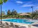 Community pool featuring clear blue water, lounge chairs, and shaded umbrellas at 2936 Aragon Terrace Way, Henderson, NV 89044