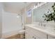 Bright bathroom with marble counter tops, a single sink vanity, and shower-tub combo at 3012 Haddon Dr, Las Vegas, NV 89134