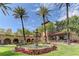 Beautiful community with lush landscaping, palm trees, and a serene water fountain feature at 3012 Haddon Dr, Las Vegas, NV 89134