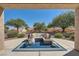 Relaxing covered patio features a comfortable seating area and views of the well-manicured backyard at 3012 Haddon Dr, Las Vegas, NV 89134