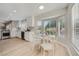 Bright dining area features a bay window, wood flooring, and modern finishes adjacent to the kitchen at 3012 Haddon Dr, Las Vegas, NV 89134