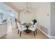 This dining area features a modern chandelier over a round glass table with seating for four at 3012 Haddon Dr, Las Vegas, NV 89134