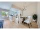 Bright dining area features a modern chandelier and stylish table setting, seamlessly flowing into the kitchen at 3012 Haddon Dr, Las Vegas, NV 89134