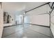 Spacious garage with epoxy floors, water heater, and plenty of room for vehicles and storage at 3012 Haddon Dr, Las Vegas, NV 89134