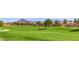 Scenic view of community golf course with mature trees and beautiful mountains at 3012 Haddon Dr, Las Vegas, NV 89134