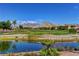 Picturesque golf course view with pond and mountain backdrop, offering serene and luxurious living at 3012 Haddon Dr, Las Vegas, NV 89134
